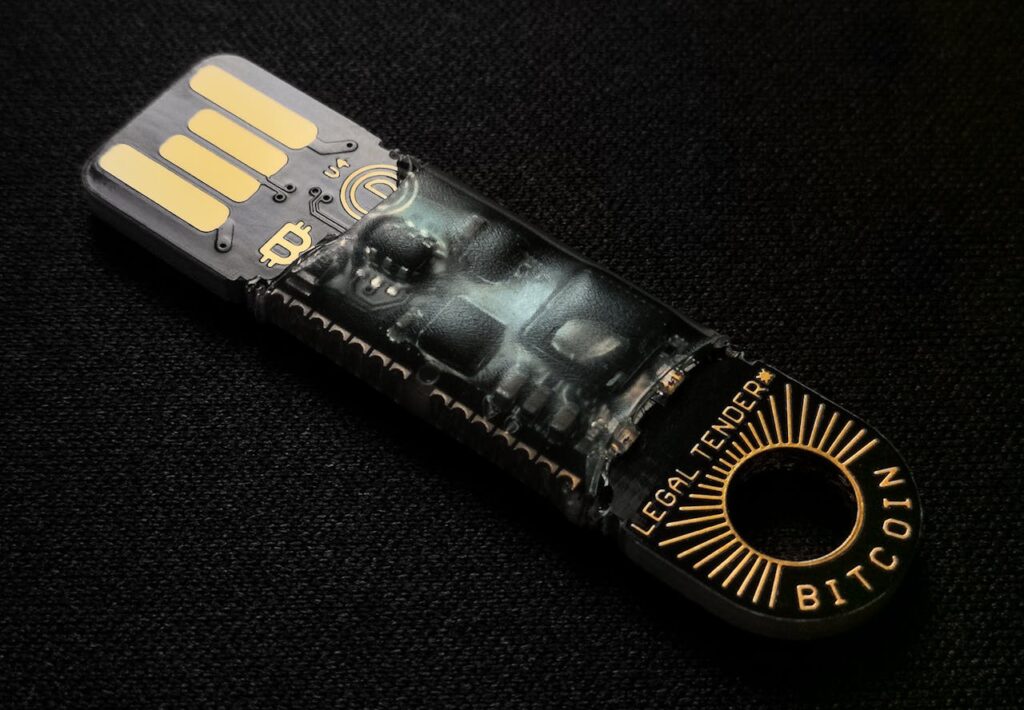 pexels-photo-3631991 A detailed close-up of a Bitcoin-themed USB device on a black background.